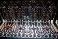 View of a vintage eclectic cast iron railing with shadows