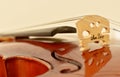 View from violin strings and bridge. Close up violin on wooden floor. Classical musical instrument. Blurry, selective focus