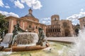 View of the Virgin Square with Valencia Cathedral and Turia Fountain under the clear, blue sky