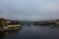 View of the Vltava river on a grey autumn day. Sad landscape in Prague. River and buildings on the banks of the Czech capital Royalty Free Stock Photo