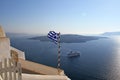 View on the volcano with Greek flag in front,Santorini island,Greece Royalty Free Stock Photo