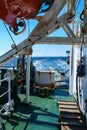 A view of the wake of the cargo ship, the deck, superstructures and units of the ship with signs of wear and rust are seen. Royalty Free Stock Photo