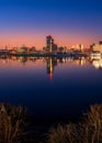 View of the warm pink sunrise over the modern skyline of Louisville KY reflected on the river water