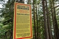 Warning sign on the Grouse Grind Trail in Vancouver emphasizing exclusion of liability and assumption of risk. These Royalty Free Stock Photo