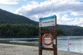 View of warning sign No lifeguard on duty at the beach of Buntzen lake recreational area Royalty Free Stock Photo