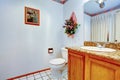 VIew of washbasin cabinet and toilet