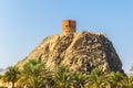 View of a watch tower behind the al riyam park in Muttrah district of Muscat, Oman Royalty Free Stock Photo