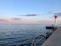 View of a watchtower at the edge of a dock before the seascape under the purple and blue shaded sky