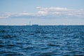 A view from the water of the Gulf of Finland on a summer day, cargo ships and ships are sailing in the distance, blue Royalty Free Stock Photo