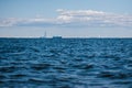 A view from the water of the Gulf of Finland on a summer day, cargo ships and ships are sailing in the distance, blue Royalty Free Stock Photo