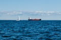 A view from the water of the Gulf of Finland on a summer day, cargo ships and yachts are sailing in the distance, blue Royalty Free Stock Photo