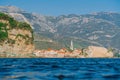 View from the water level to the old town of Budva from the sea. The old town against the mountains. The fortress wall Royalty Free Stock Photo