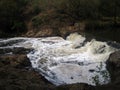 WATER CASCADING OVER A WEIR IN A RIVER Royalty Free Stock Photo