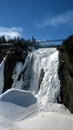 view of a waterfall under a beautiful winter day in Quebec Canada Royalty Free Stock Photo