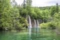 View of waterfalls with turquoise water and green trees in Plitvice Lakes National Park in summer, Croatia Royalty Free Stock Photo