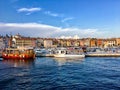 A view of the waterfront of Rovinj, Croatia full of colourful old buildings and boats docked in the bay.