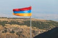 View of waving flag of Armenia with mountain landscape in the background, armenian tricolor flag in summer sunny day