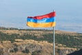 View of waving flag of Armenia with mountain landscape in the background, armenian tricolor flag in summer sunny day