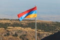 View of waving flag of Armenia with mountain landscape in the background, armenian tricolor flag in summer sunny day