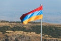 View of waving flag of Armenia with mountain landscape in the background, armenian tricolor flag in summer sunny day