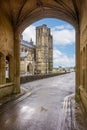 View of Wells cathedral looking through the medieval arch over St Andrews Street in Wells, Somerset, UK