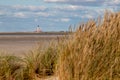 View of the Westerheversand lighthouse from the dunes in front of St. Peter Ording Royalty Free Stock Photo
