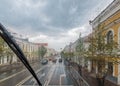 View of the wet city street and the road through the windshield in the rain drops Royalty Free Stock Photo