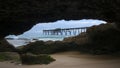 view of a wharf from inside a cave on a beach at catherine hill bay Royalty Free Stock Photo