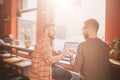 A view where two best friends are sitting at the table and having conversation. They are in cafe in a beautiful sunny Royalty Free Stock Photo