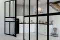 View on a white and black kitchen through the black glass french door with Christmas New year decor