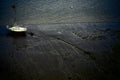View of white boat stranded at the low tide of river Thames banks in the evening Royalty Free Stock Photo
