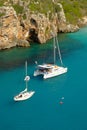 View on white boats on the beach Cala en Porter, Menorca