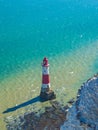 View of the white chalk headland cliffs and Beachy Head Lighthouse in the Seven Sisters National park, Eastbourne, England. Royalty Free Stock Photo