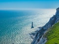 View of the white chalk headland cliffs and Beachy Head Lighthouse in the Seven Sisters National park, Eastbourne, England. Royalty Free Stock Photo