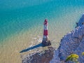 View of the white chalk headland cliffs and Beachy Head Lighthouse in the Seven Sisters National park, Eastbourne, England. Royalty Free Stock Photo