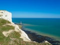 View of the white chalk headland cliffs and Beachy Head Lighthouse in the Seven Sisters National park, Eastbourne, England. Royalty Free Stock Photo