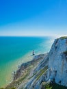 View of the white chalk headland cliffs and Beachy Head Lighthouse in the Seven Sisters National park, Eastbourne, England. Royalty Free Stock Photo