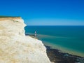 View of the white chalk headland cliffs and Beachy Head Lighthouse in the Seven Sisters National park, Eastbourne, England. Royalty Free Stock Photo