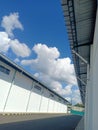 view of white clouds between buildings in Kartasura