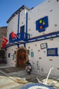 View of white house with blue door and windows in Bodrum city of Turkey.