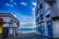 View of the white houses with blue shutters on the background of the oceans on the Spanish island of Furertaventra