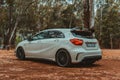 View of a white Mercedes Benz AMG A45 car in a forest Royalty Free Stock Photo