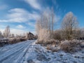 View of white winter landscape with trees covered with snow, frozen country road after a heavy snowfall Royalty Free Stock Photo