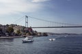 View of a white yacht, small boats, FSM bridge