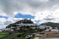 View of the whitwashed Andalusian village of Zahara de la Sierra and its Moorish Castle on the hilltop