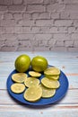 View of whole limes and slices of fresh lime Royalty Free Stock Photo