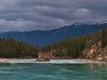 View of wild Athabasca River in the Rocky Mountains in Jasper National Park, Alberta, Canada on cloudy day in autumn. Royalty Free Stock Photo