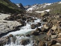 View of wild spring stream at green alpine mountain valley at Stubai hiking trail, Stubai Hohenweg, Summer rocky Royalty Free Stock Photo