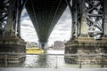 View of Williamsburg Bridge beneath. Looking at Brooklyn side and a NYC water taxi