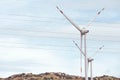 View of wind farm with high wind turbines for generation electricity